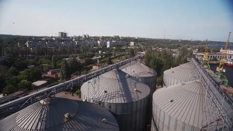Modern grain elevator terminal in sea port. Metal tanks and conveyors of grain Stock Footage 244746315
