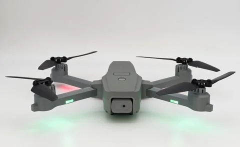 Modern gray drone capturing aerial photography on a white background Stock Photos