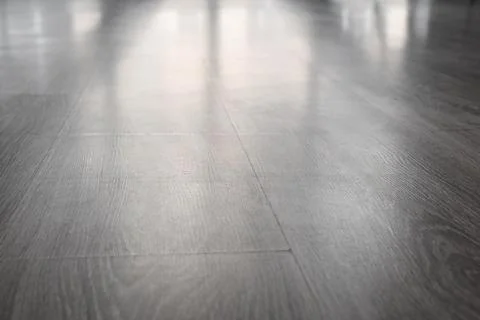 Modern gray laminate flooring with subtle reflections, durable home interior  Stock Photos
