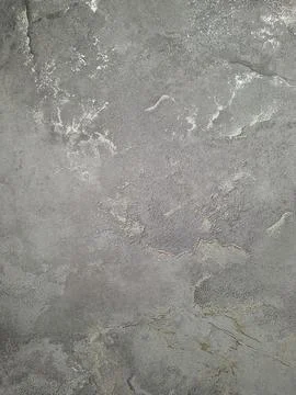 Modern gray plaster wall with abstract patterns and metallic shimmer for cr.. Stock Photos