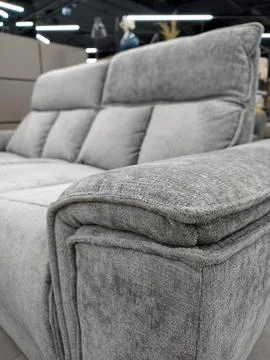 A modern gray sofa with the camera focused on the armrest, available in a f.. Stock Photos