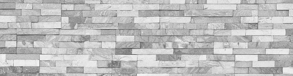 Modern gray stone cladding wall creating a seamless textured surface Stock Photos