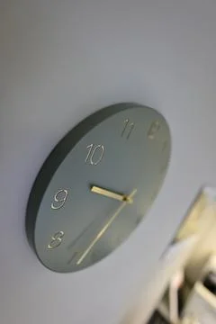 Modern Gray Wall Clock with Gold Hands Stock Photos