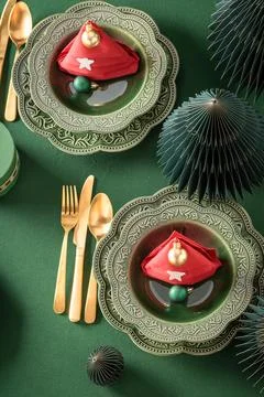 Modern green table display with festive baubles. Stock Photos