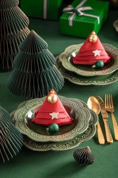 Modern green table setting adorned with baubles. Stock Photos