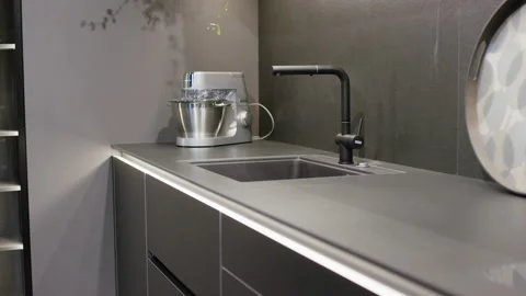 Modern grey kitchen interior with black faucet sink and silver food processor Stockbeeldmateriaal 155206992