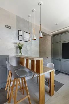 Modern Grey Kitchen with Wooden Elements and Dining Space Stock Photos