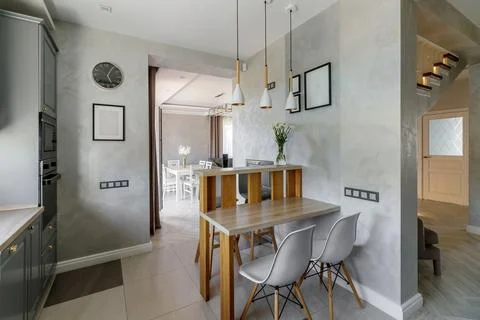 Modern Grey Kitchen with Wooden Elements and Dining Space Stock Photos