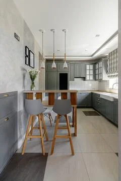 Modern Grey Kitchen with Wooden Elements and Dining Space 스톡 사진