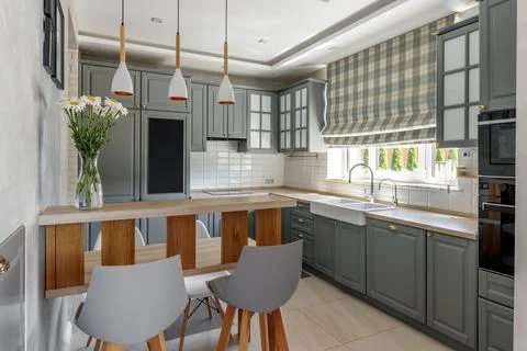 Modern Grey Kitchen with Wooden Elements and Dining Space Stock Photos