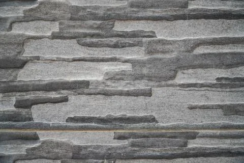 Modern Grey Stone Tile Wall with Uneven Stacked Textured Design Stock Photos