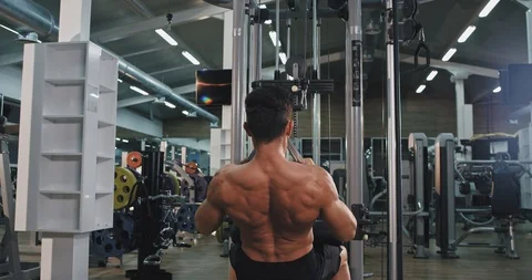 Modern gym class young guy doing hard workout for his biceps and triceps lifting Video stock 115938260
