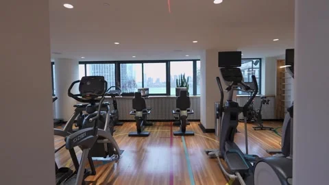 The modern gym interior features a stunning view and a wide range of equipment Vídeos de archivo 295077177