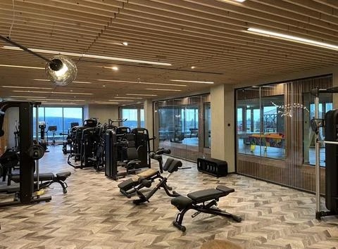 Modern Gym Interior with Various Exercise Equipment Stock Photos