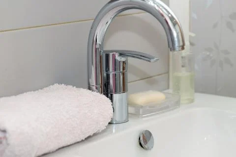 Modern hand wash basin. Solid tabletop surface and gray tile wall. Stock Photos