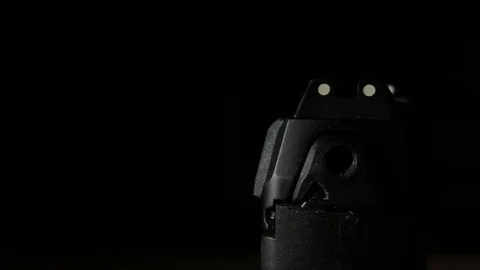 Modern Handgun in low light key Stock Footage
