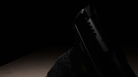 Modern Handgun in low light key Stock-Footage 80660718