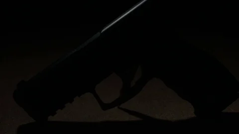 Modern Handgun in low light key Stock-Footage 80660745