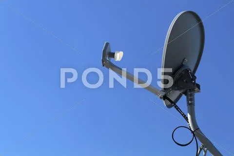 Modern HD Satellite Dish On A Clear Blue Sky Day Stock Photos