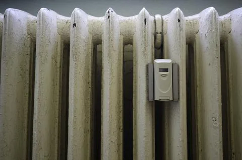 A modern heat cost allocator on an old sectional radiator Stock Photos