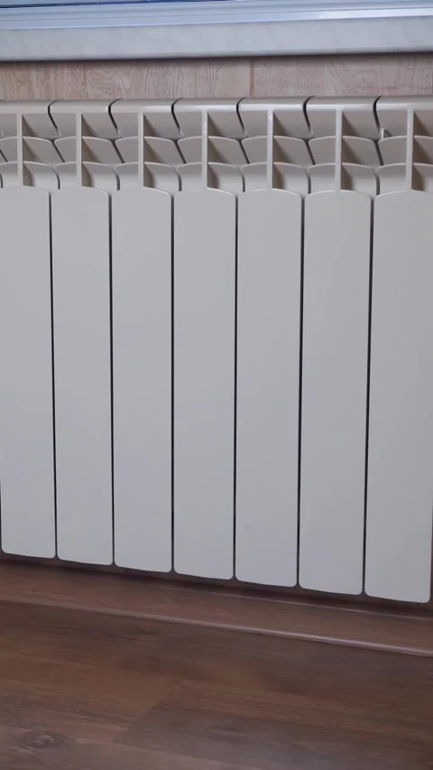 Modern heating radiator under the window of the house Stock-Footage 318072310