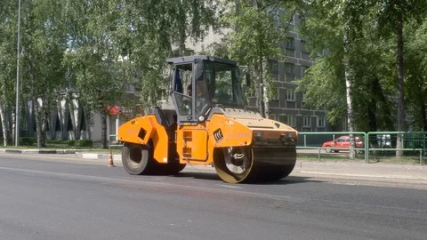 Modern heavy asphalt roller that stack and press hot asphalt. Stock Footage 111141899