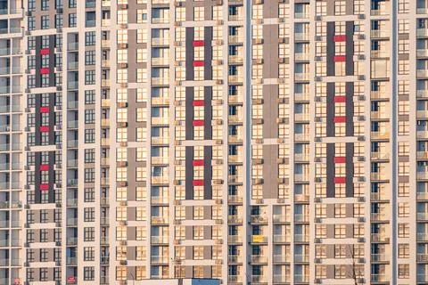 Modern high-rise building, rectangular windows and balconies, vibrant contras Stock Photos