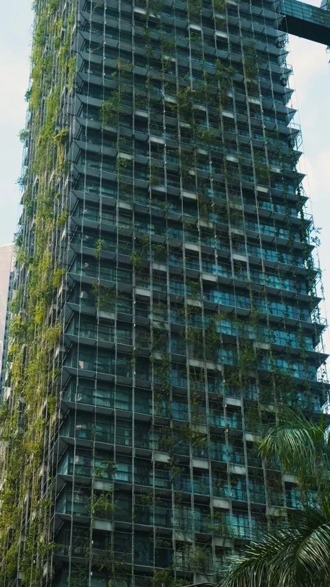 Modern high-rise building with vertical gardens integrated into its architecture Stock Footage 288095421