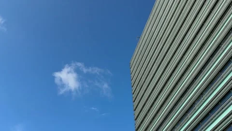 Modern High Rise Facade Beside White Cloud and Blue Sky Stock Footage 340512522
