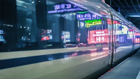 Modern high speed passenger train leaves station in Shanghai, China. Stock Footage