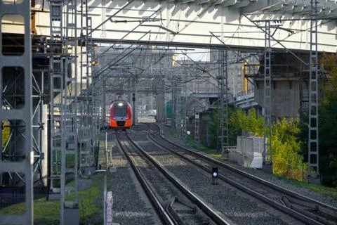 A modern high-speed red train on a section of the Moscow Central Circle Line. Stock Photos