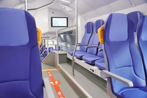 Modern high speed train interior with empty blue seats Stock Photos