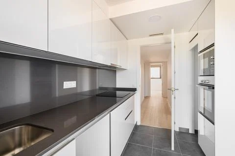 Modern high tech kitchen in black and white with modern appliances and furniture Stock Photos