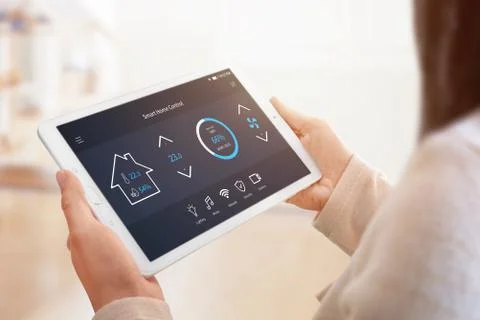 Modern home control app with flat interface on tablet display. Woman holding  Stock Photos