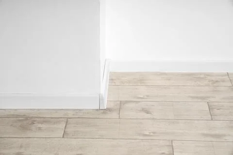 Modern home interior design with light wood laminate flooring and white baseb Stock Photos