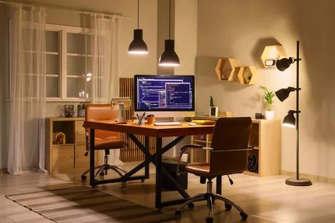 Modern home office with computer programming on screen Stock Photos