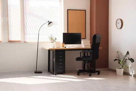 Modern home office interior with computer monitor, desk, ergonomic chair, and Stock Photos