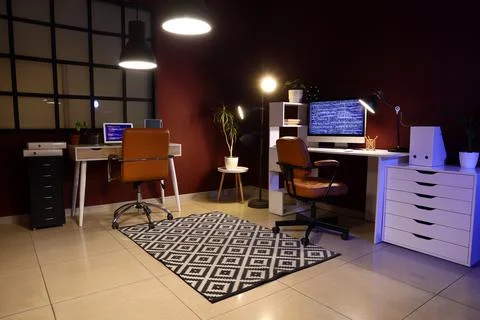 Modern home office interior with two computer workstations and coding on scre Stock Photos