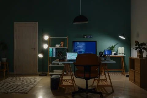 Modern home office with multiple screens displaying code 스톡 사진