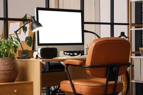Modern home office setup with computer and virtual reality headset Stock Photos