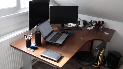 Modern home office setup with dual monitors laptop and wireless keyboard on dark Stock Footage 309334537