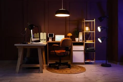 Modern home office workspace with computer and desk lamp Stock Photos