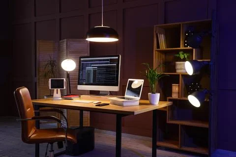 Modern home office workspace with computer and laptop Stock Photos