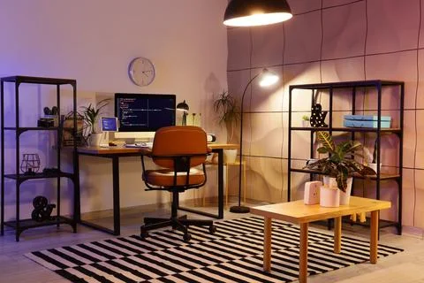 Modern home office workspace with computer and plants Stock Photos