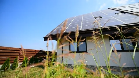 Modern home with solar and thermal renewable energy panels on the roof Stock Footage