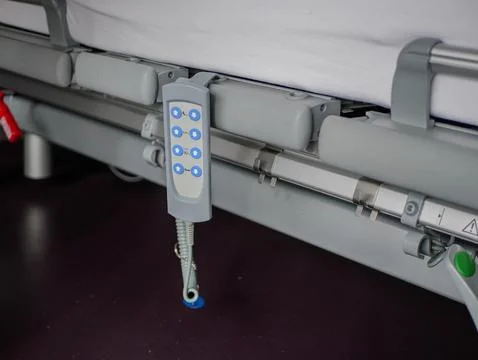 Modern hospital bed control panel close-up with adjustment buttons for patien Stock Photos