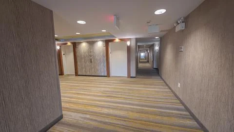 Modern hotel hallway with elevators and patterned carpet in Charlotte Stock Photos