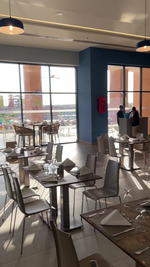 Modern hotel restaurant dining hall with blue and yellow pillars on June 20, Stock Footage 337298512