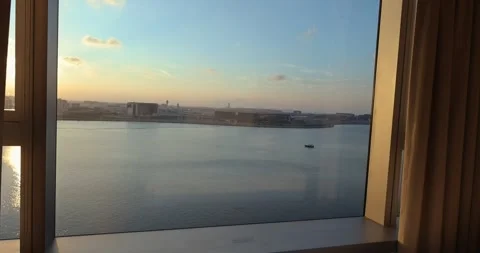 Modern Hotel Room View Overlooking Coastal City at Sunset Stockbeeldmateriaal 331507926
