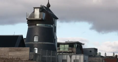 A modern house converted from an old windmill by the beach in Aldeburgh, Suff Stock Footage 337590162